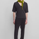 man wearing dark grey loose-fit cashmere pants with a drawstring waistband and side pockets.