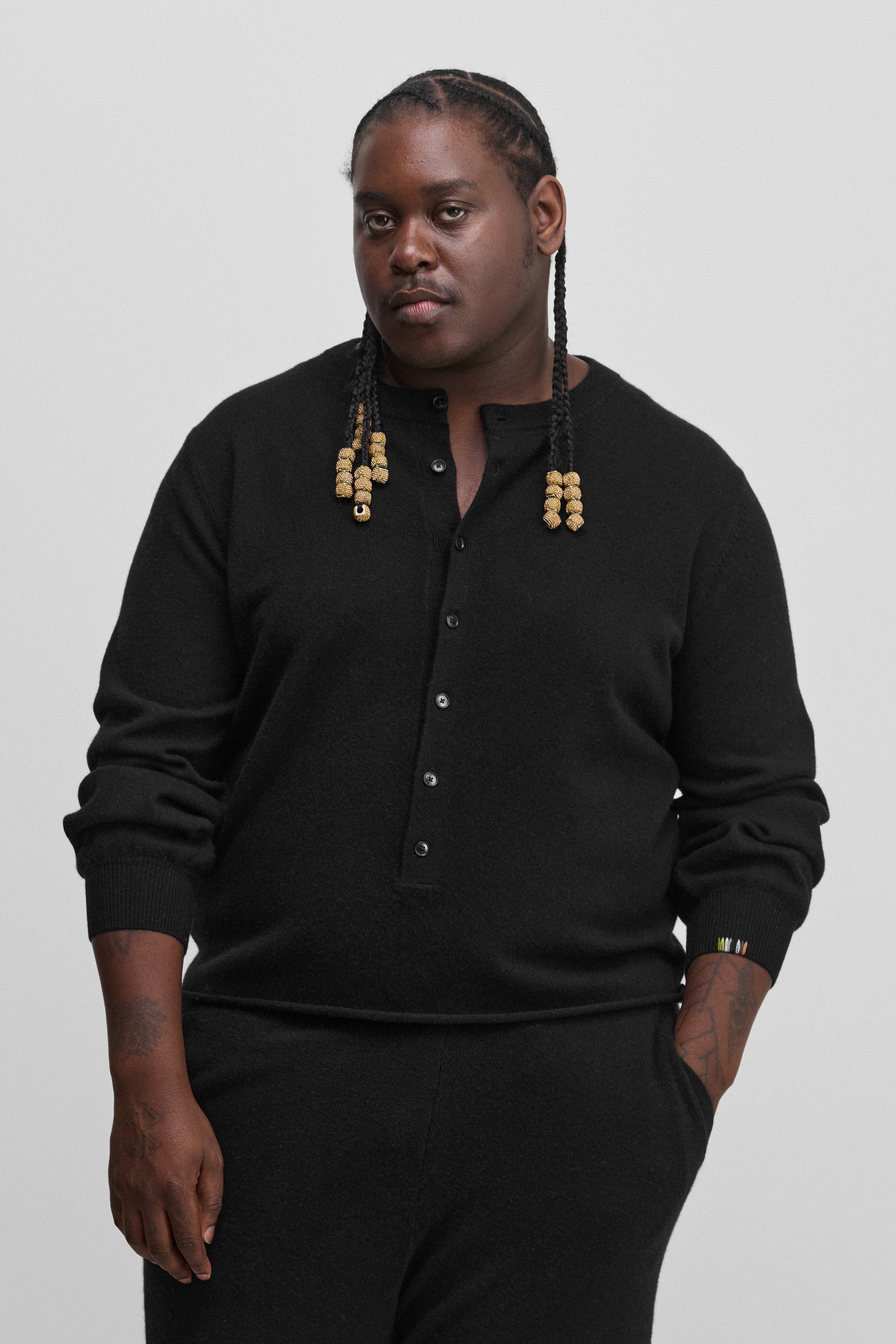 man wearing a black cashmere sweater with corozo buttons.
