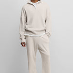man wearing off-white loose-fit cashmere pants with two side pockets.