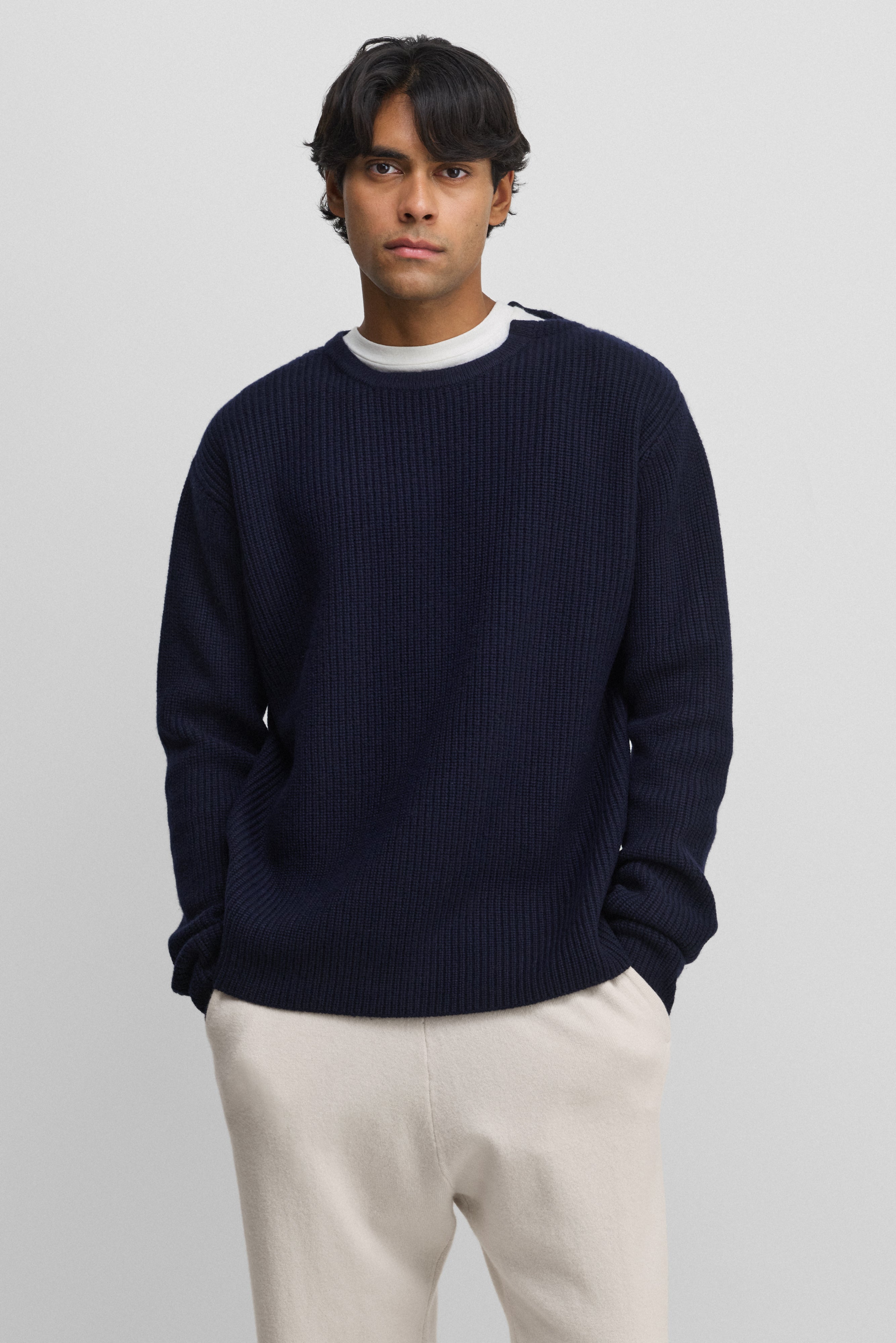 man wearing a navy blue ribbed cashmere crew-neck sweater.