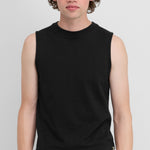 man wearing a fitted black sleeveless cotton-cashmere top with a crew neck.