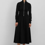 woman wearing a long black cashmere circle skirt with ribbed waistband.