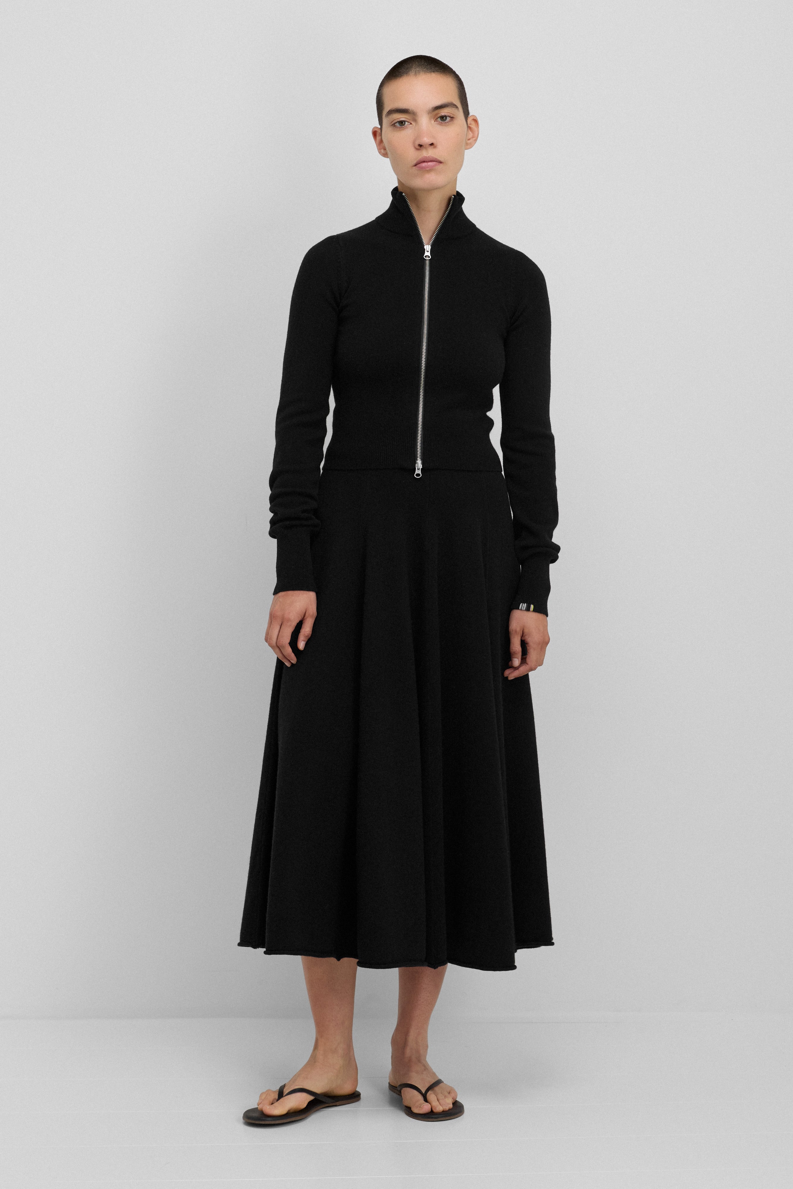 woman wearing a long black cashmere circle skirt with ribbed waistband.