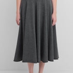 woman wearing a dark grey flared cashmere midi skirt with ribbed waistband.