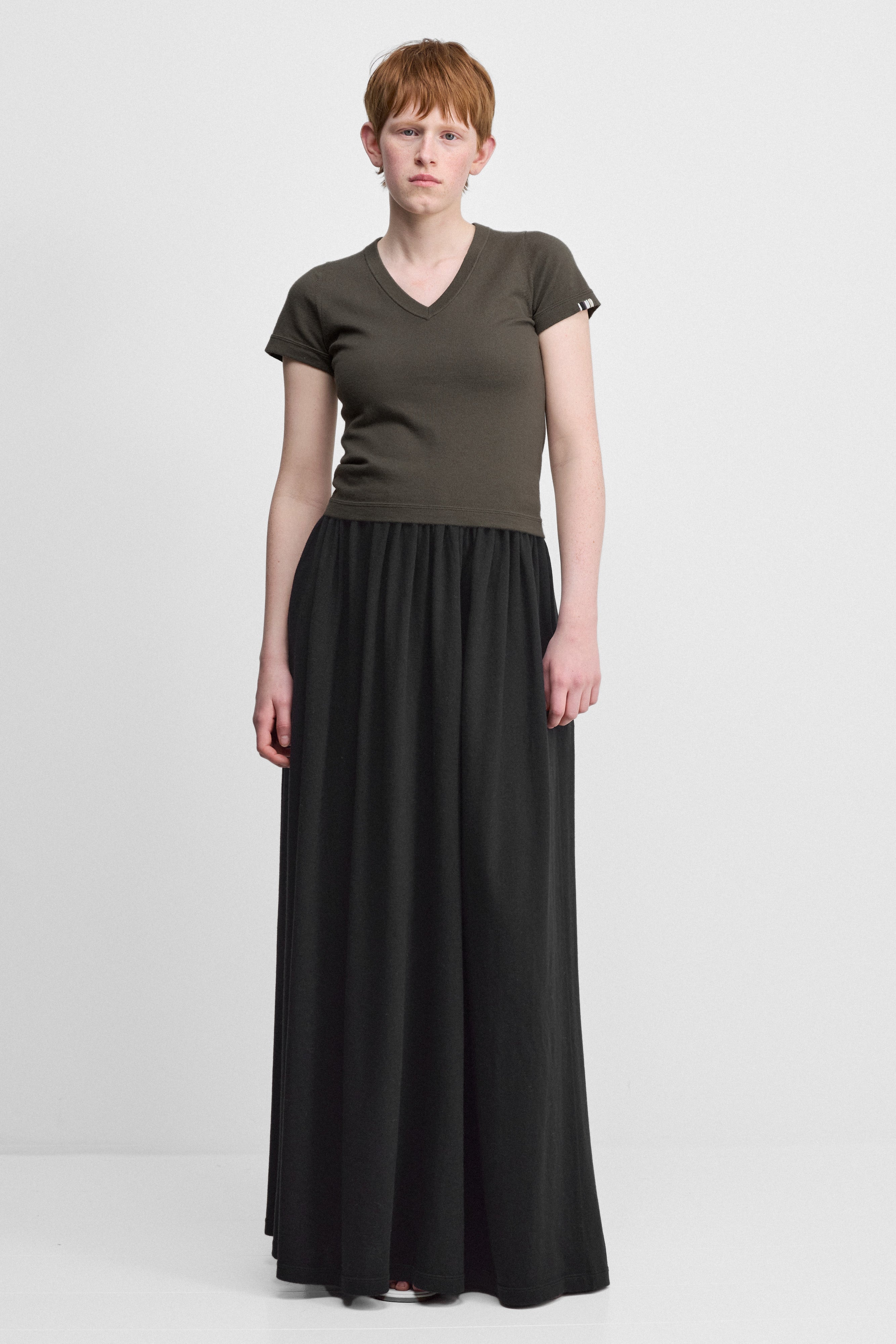 woman wearing a black cotton cashmere maxi skirt with an elastic waistband and side pockets.