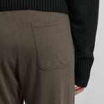 detail of the back pocket of army green cotton cashmere pants.