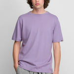 man wearing a lavender purple short-sleeved cotton cashmere crewneck t-shirt.