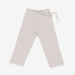 white rib-knit cashmere pants with straight legs and a drawstring waist, laid flat.