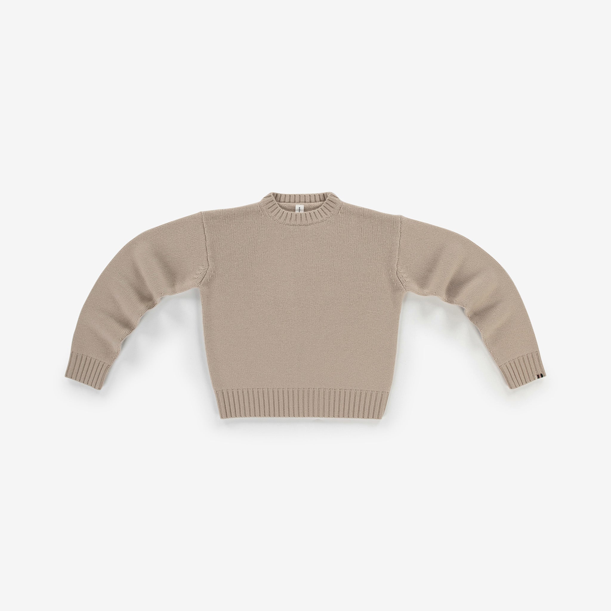 light beige cashmere crew-neck sweater with ribbed trims, laid flat.