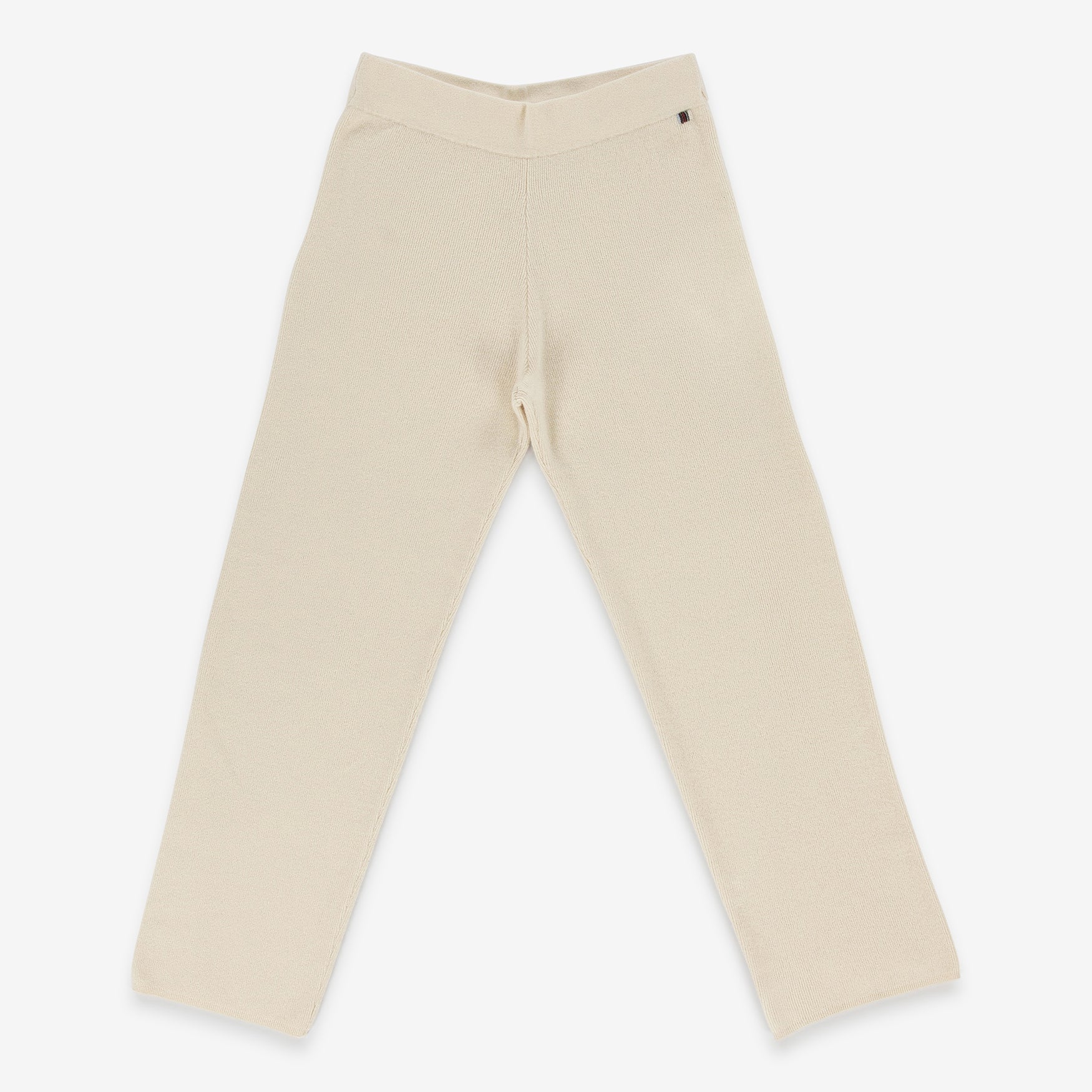 cream rib-knit cashmere pants with straight legs and a drawstring waist, laid flat.